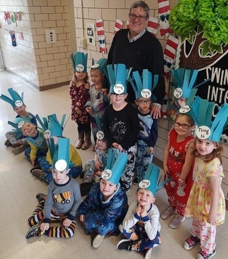 Superintendent Mike Masloski with elementary students dressed as wild things for a reading program