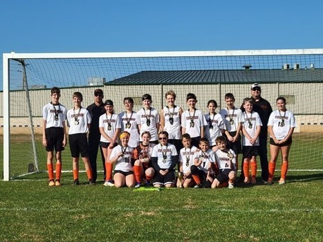 Girls Soccer Team in front of goal.