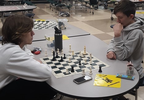 Two boys playing chess.